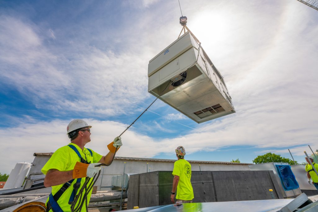 Mazza mechanical team installing and industrial hvac unit. Preventative Maintenance